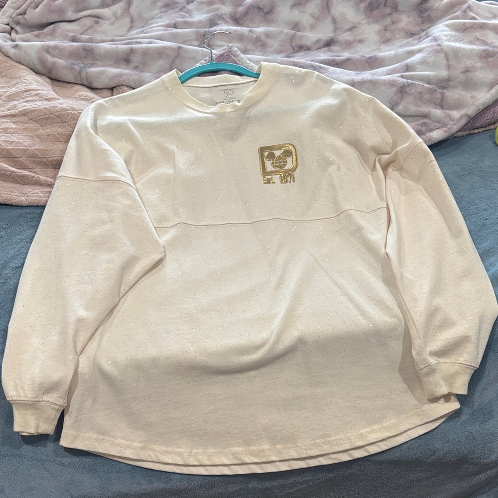 Cream Long Sleeve Sweatshirt with Gold Disney 50th anniversary shirt.